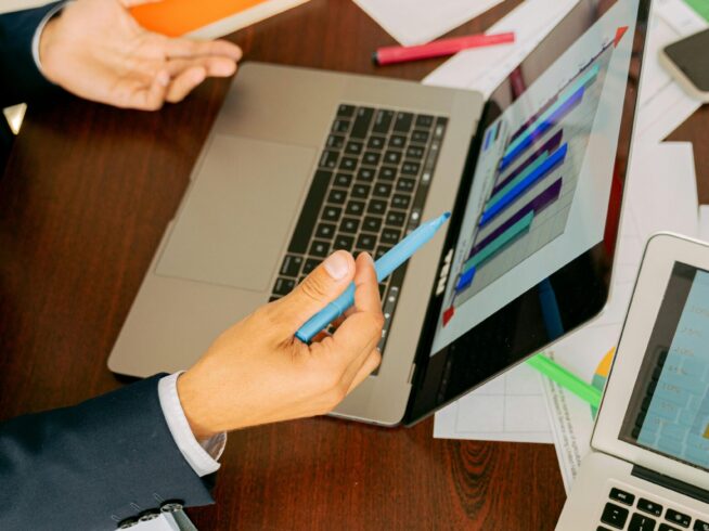 Free A Person in Black Suit Holding a Pen Stock Photo