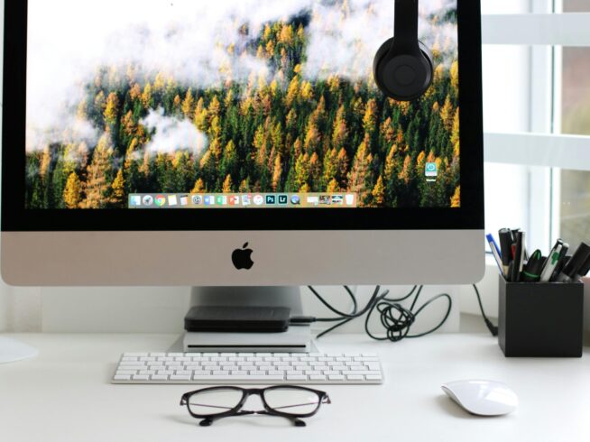 Free Stylish home office workspace featuring a computer setup with accessories. Stock Photo