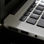 Free Detailed view of a silver laptop showing keyboard and multiple ports. Stock Photo