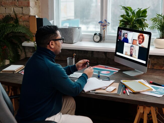 teacher-video-calling-with-his-students-using-a-computer